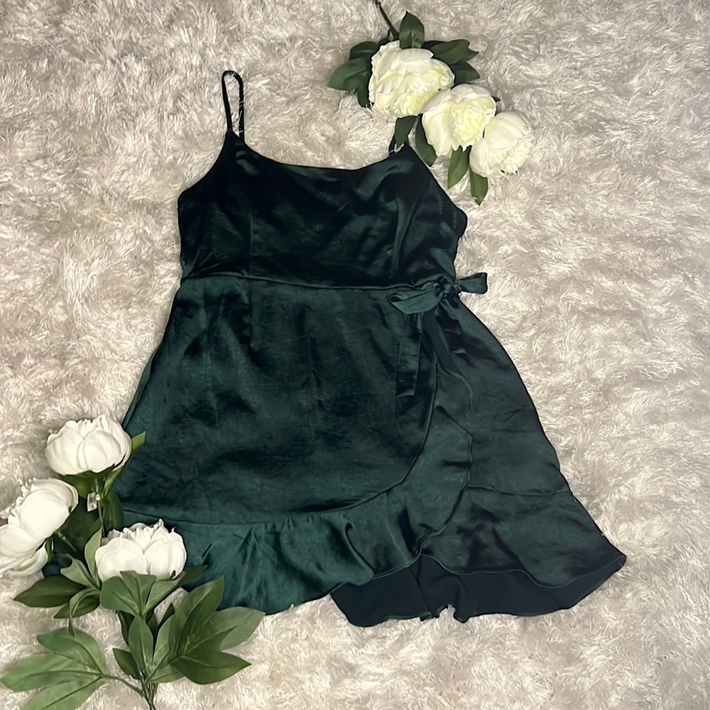 A cute summer emerald silk dress in good condition cute for a day or night out.